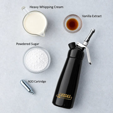 Whipping cream, icing sugar and cream siphon arranged for a professional whipped cream ratio recipe